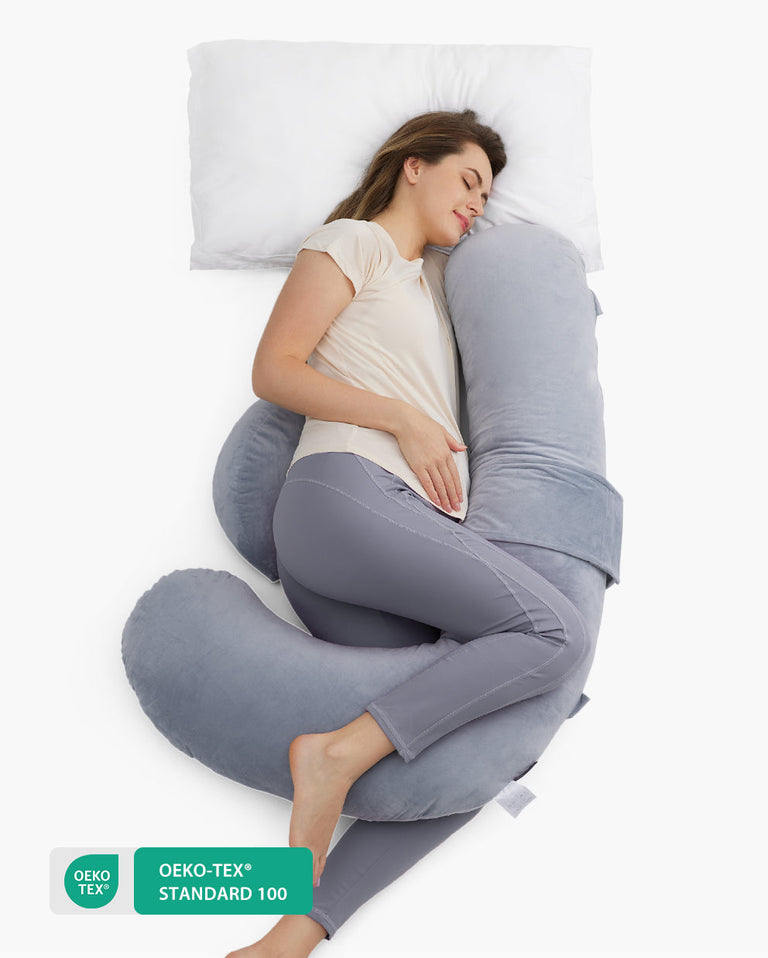 Translation missing: en.F-shaped pregnancy pillow supporting a pregnant woman. Oeko-Tex Standard 100 certified for safe, comfortable sleep