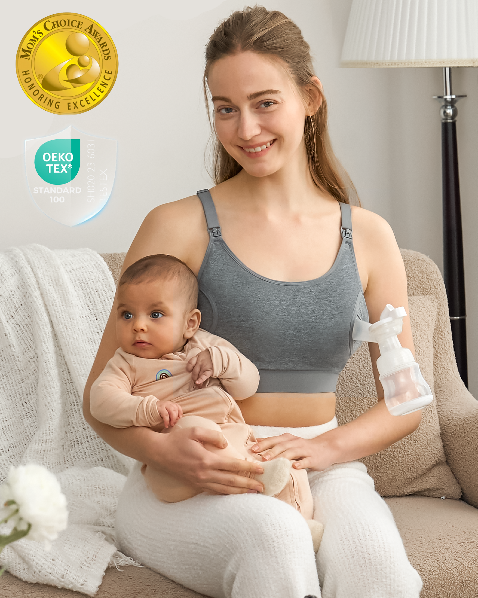 Mom in heather grey hands-free pumping bra, cuddling baby while pumping. Adjustable, Mom's Choice & OEKO-TEX certified.