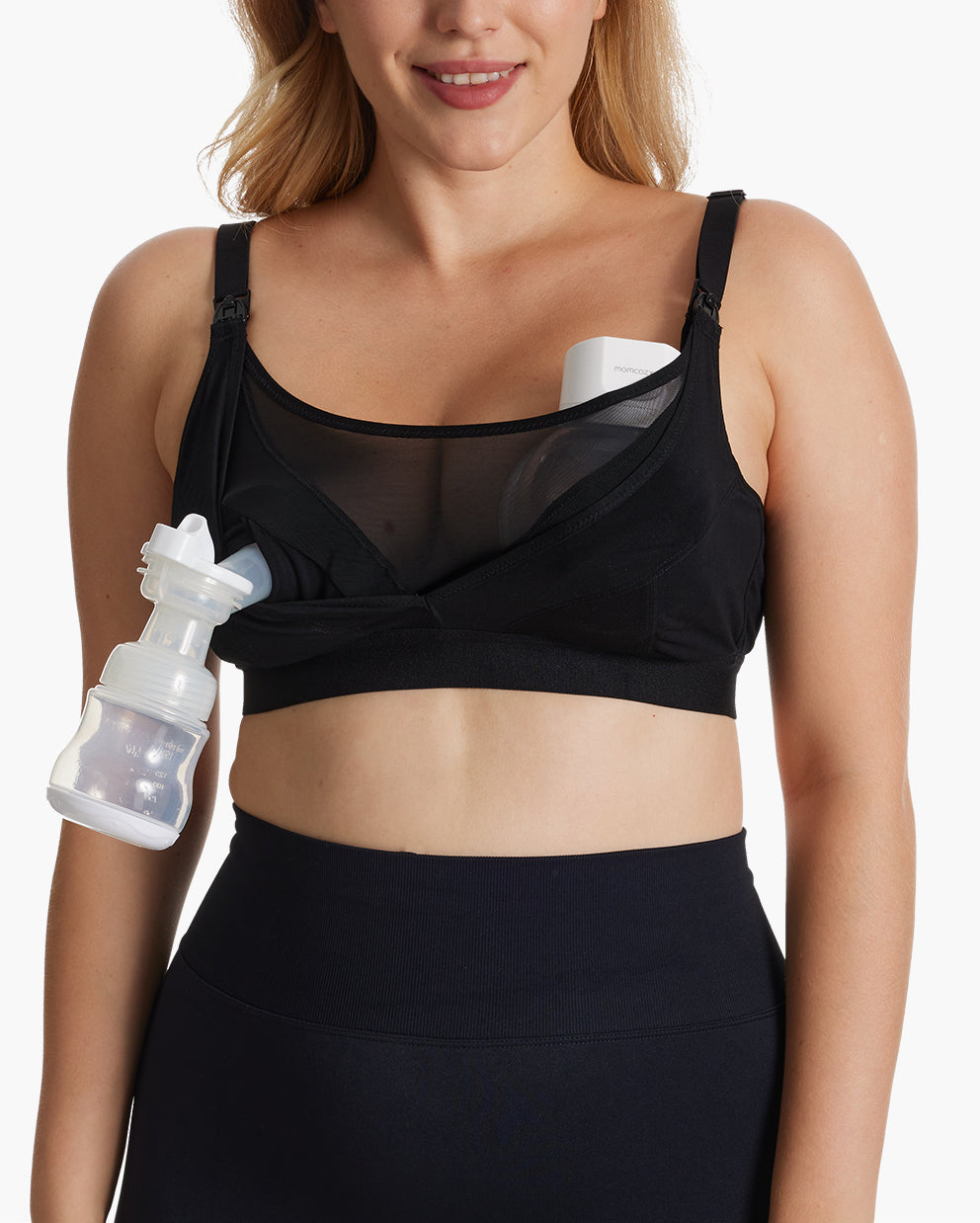 Woman demonstrating the functionality of the Momcozy Bamboo Ultra-Soft & Cool Breeze Pumping & Nursing Bra (HF018) with a wearable breast pump.