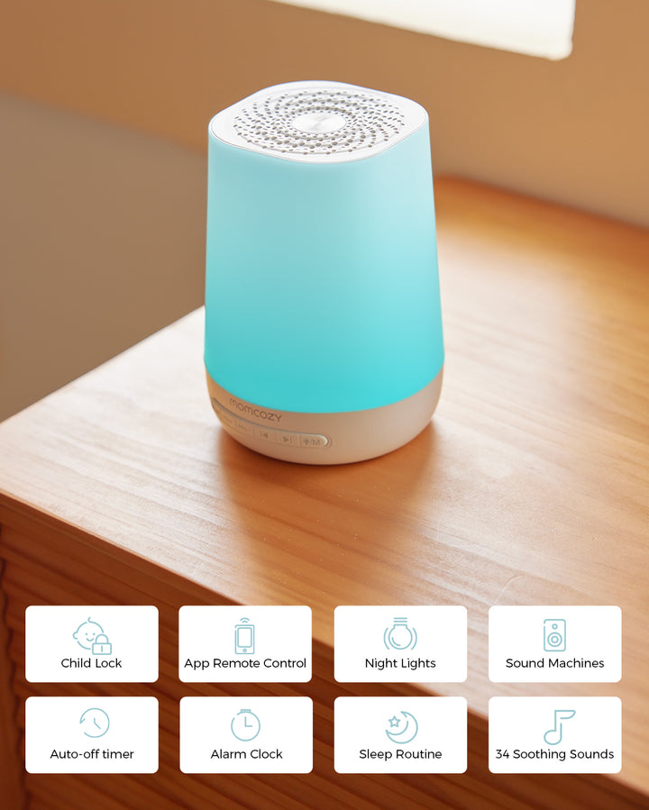 Smart baby sound machine by Momcozy with blue light, showing features including child lock, app remote control, night lights, sound machines, auto-off timer, alarm clock, sleep routine, and 34 soothing sounds.