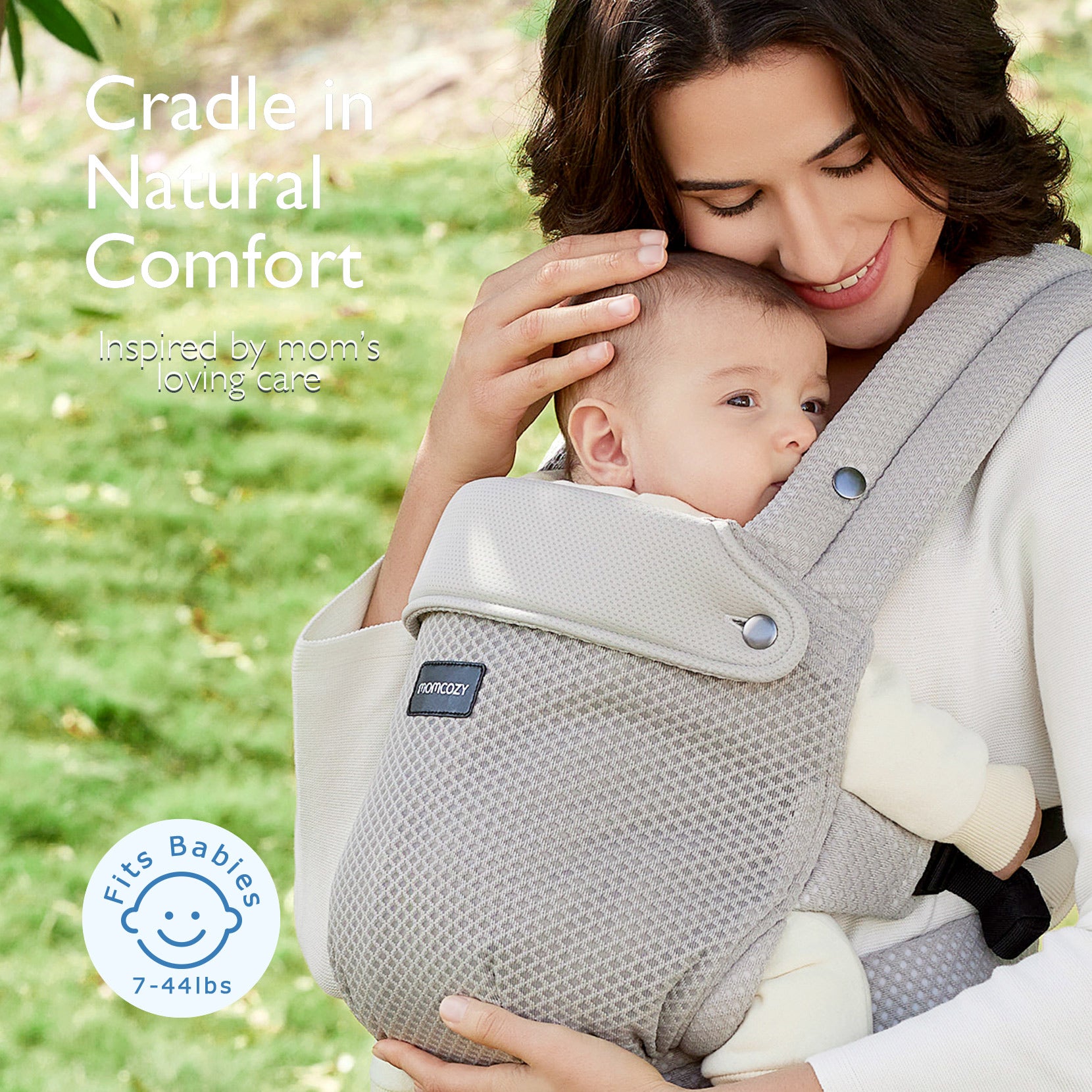 Momcozy PureHug baby carrier. Grey carrier, comfortable design for babywearing. Mom holding baby. Supports 7-44lbs.