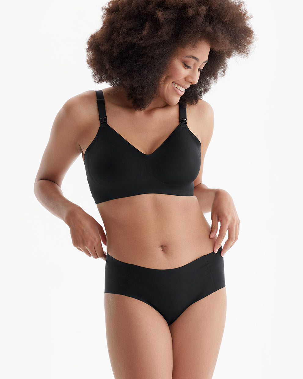 Smiling model in black Ultra Soft Seamless Nursing Bra YN21, showing comfortable, flattering fit and M5 pump compatibility.